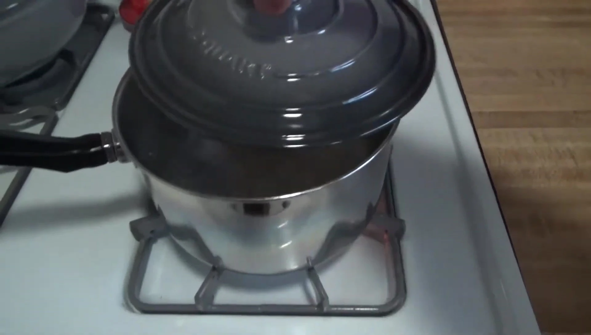Pot of boiling water ready to be added to the grill.