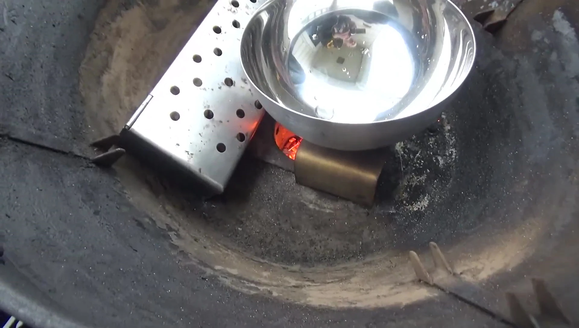 Boiling water being poured into the water pan.