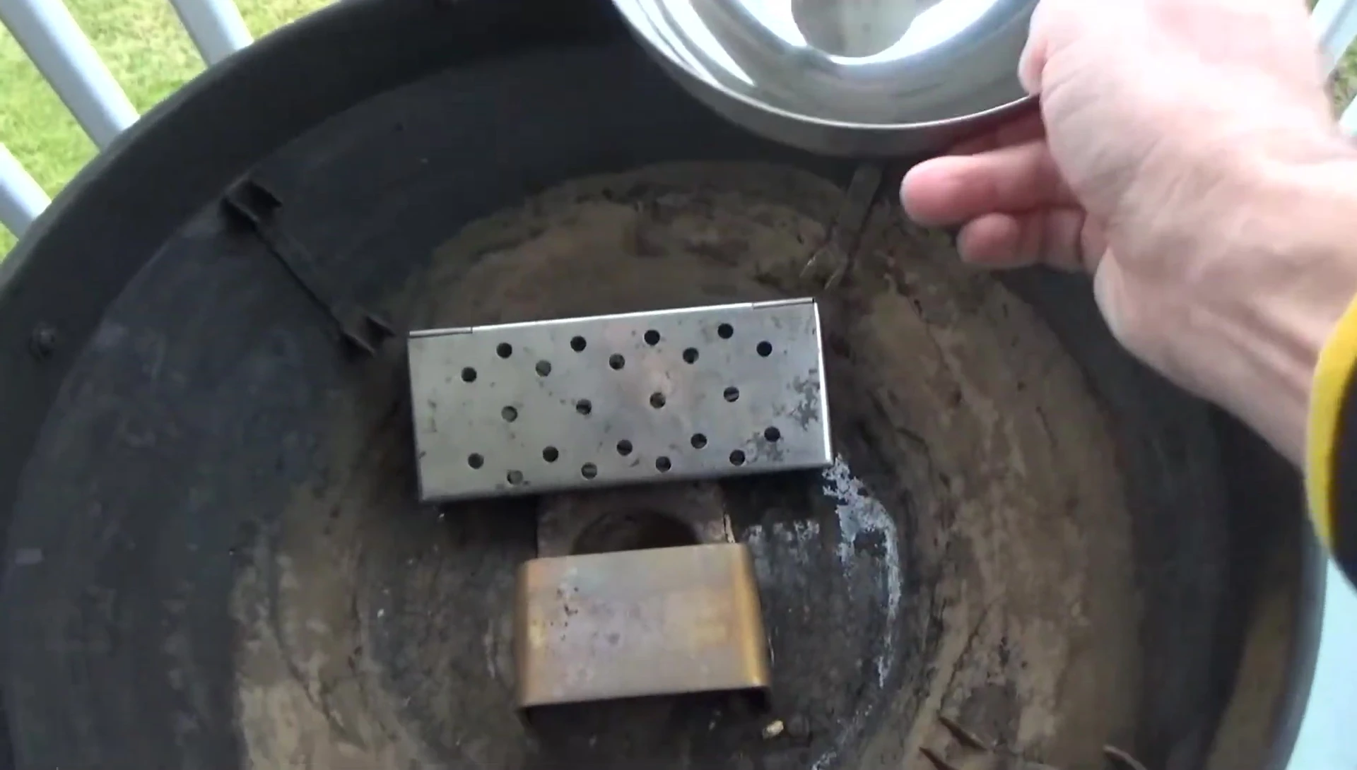 Overview of the grill setup, highlighting the water bowl and heat deflector.