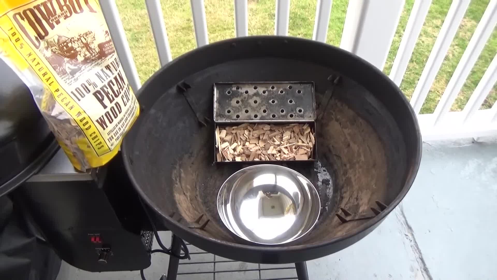 Close-up shot of the Rec Tec Bullseye pellet grill setup with the smoke box and water pan.