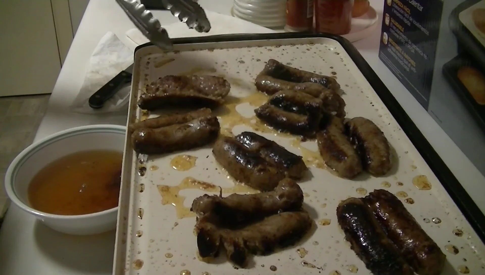 Final shot of the cooked bacon and sausages, highlighting the even cooking and lack of sticking.