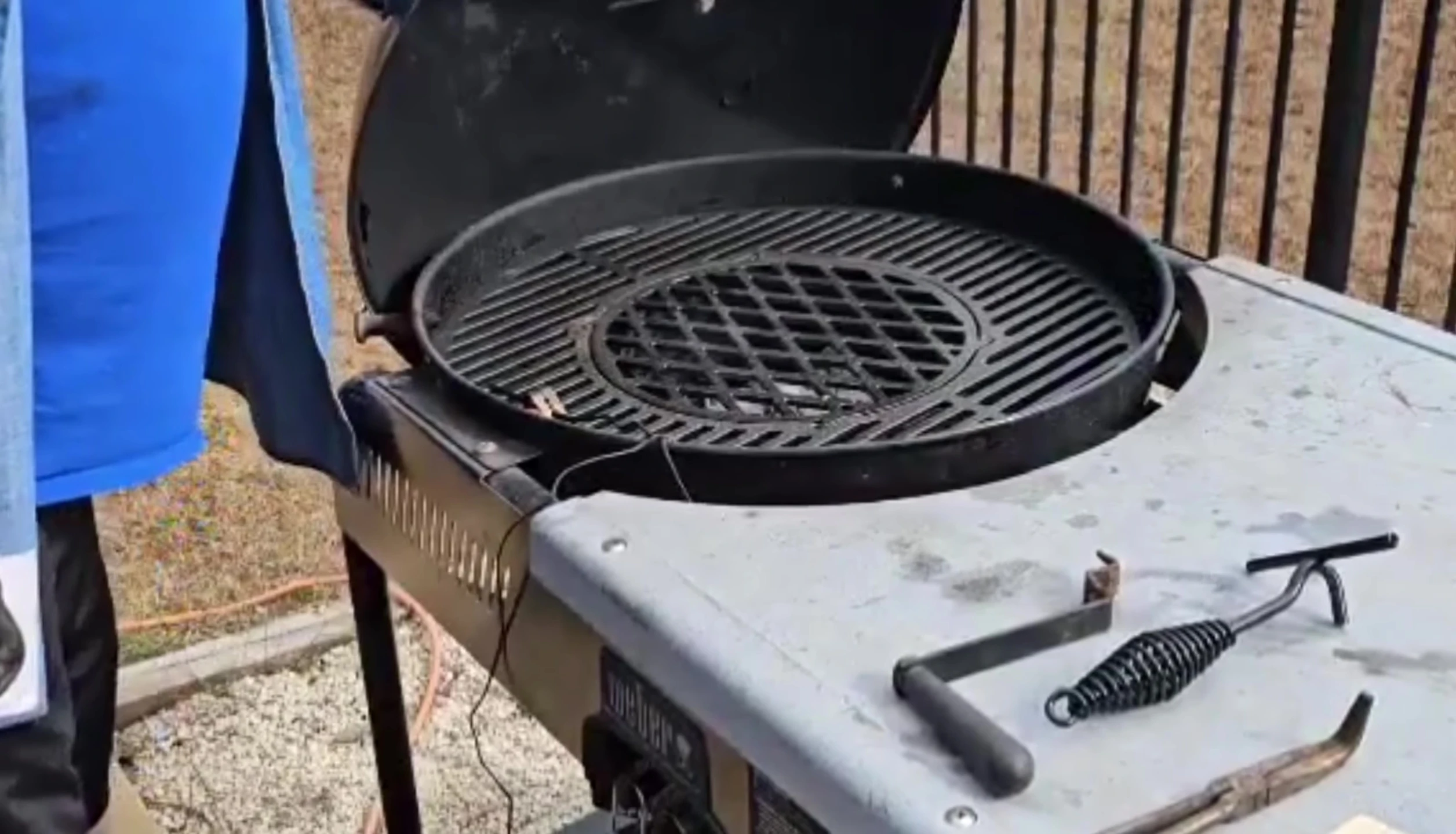 Removing the centerpiece of the cast iron grate.