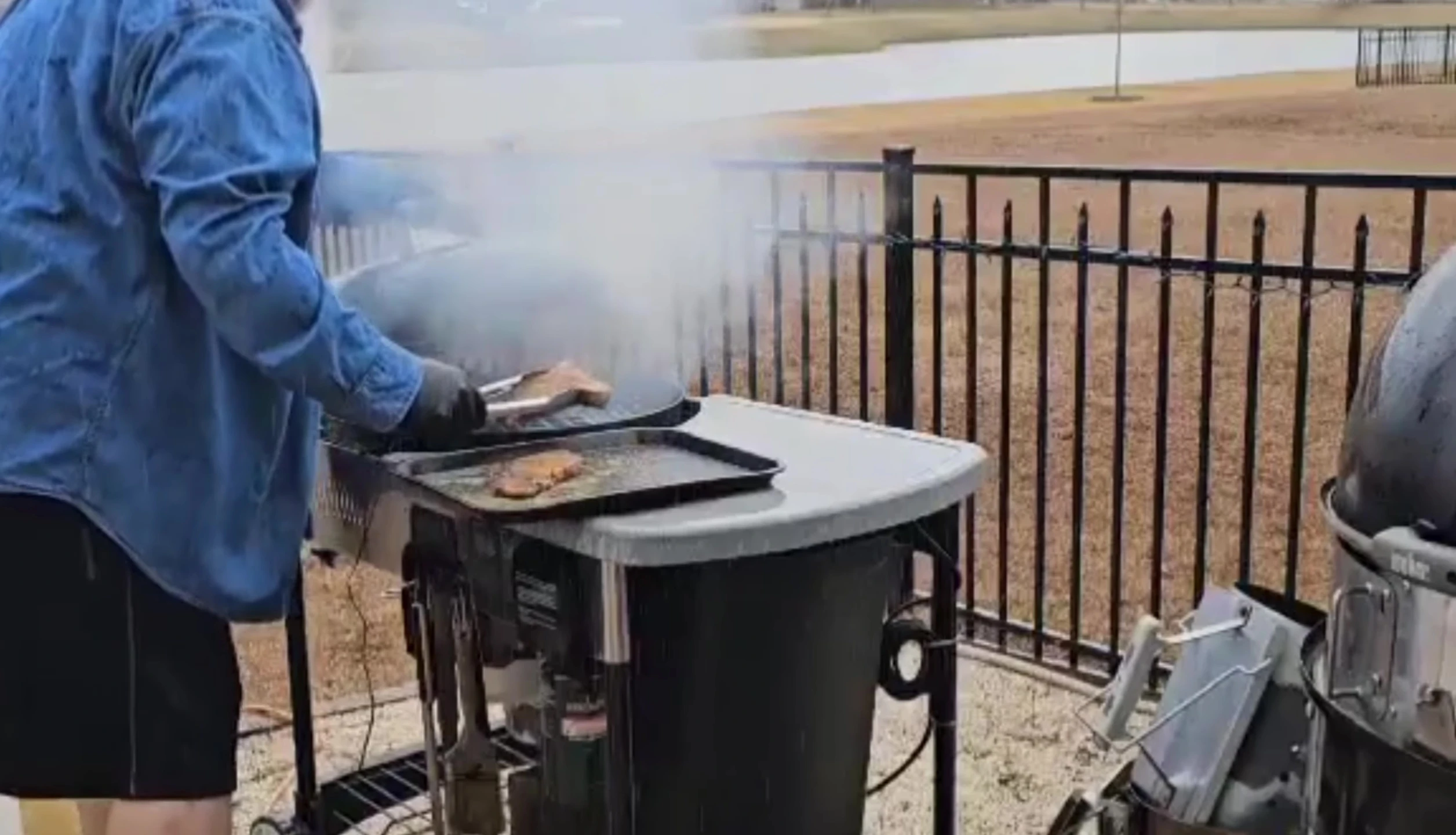 Preparing New York strip steaks for cooking.