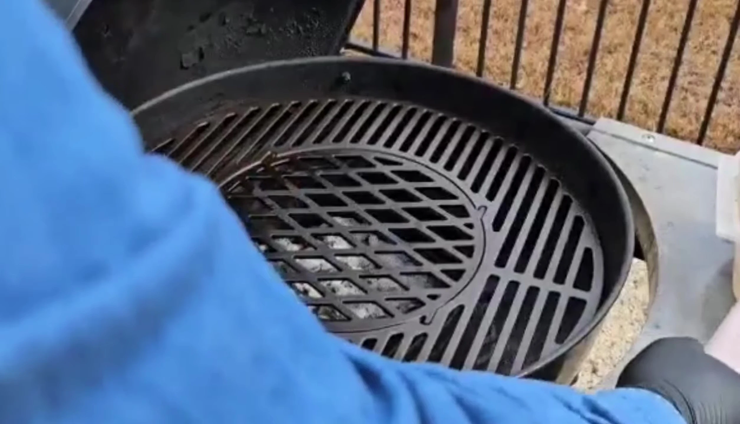 Cleaning the hot cast iron grate.