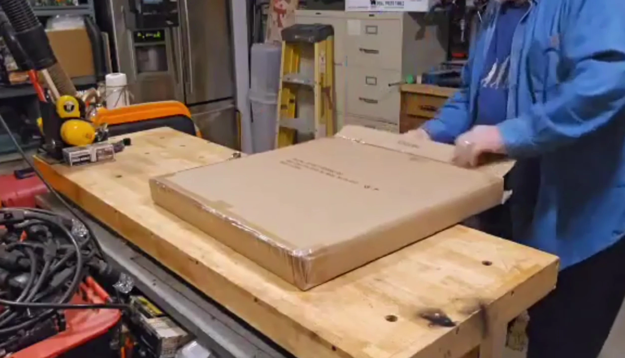 Opening the package to reveal the cast iron grate.
