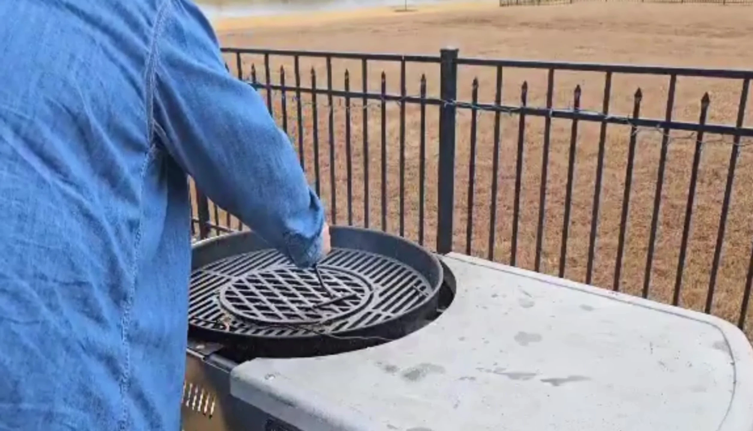 Applying avocado oil to season the cast iron grate.