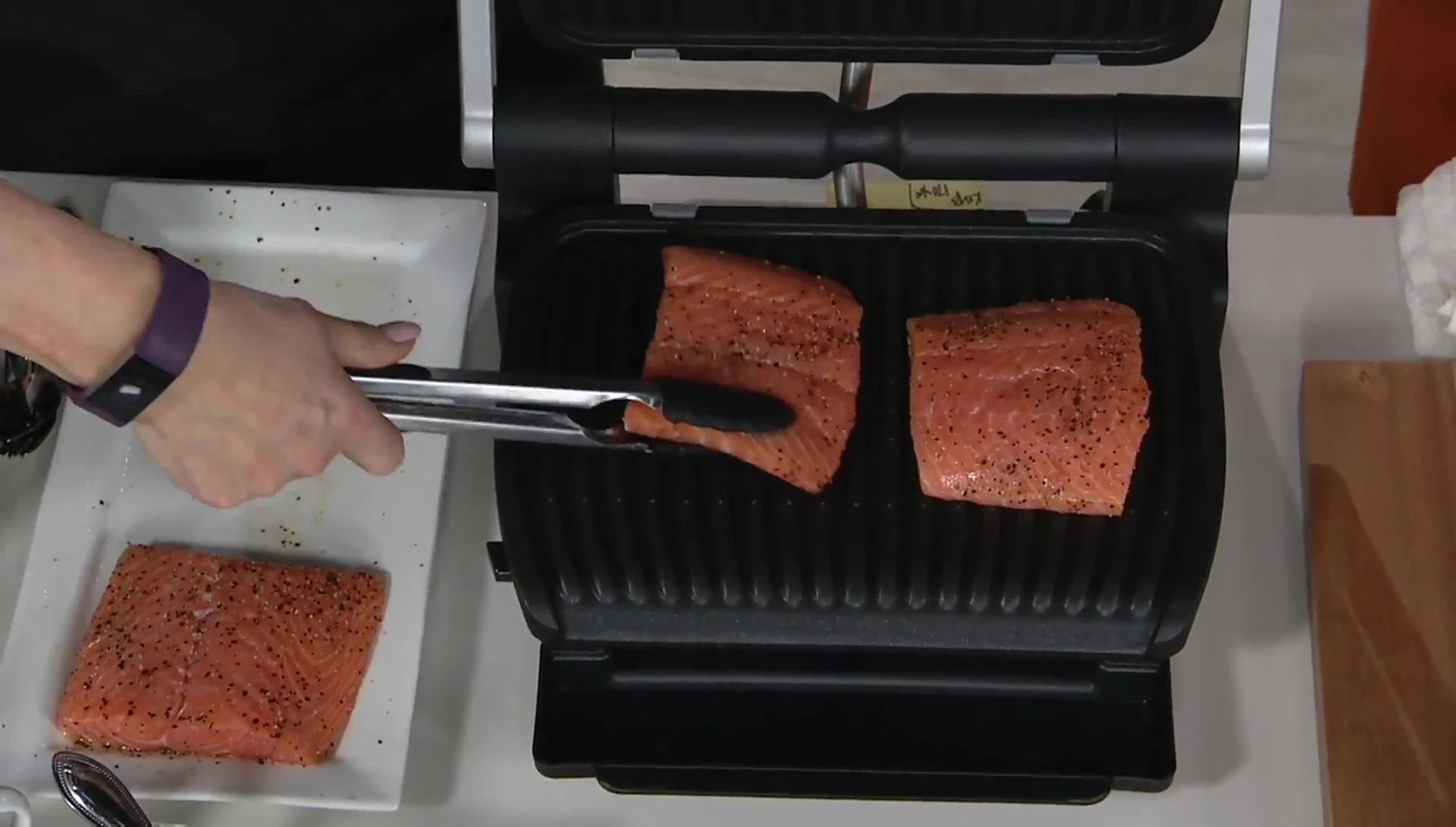 The host holding the grill, showcasing its size and appearance.