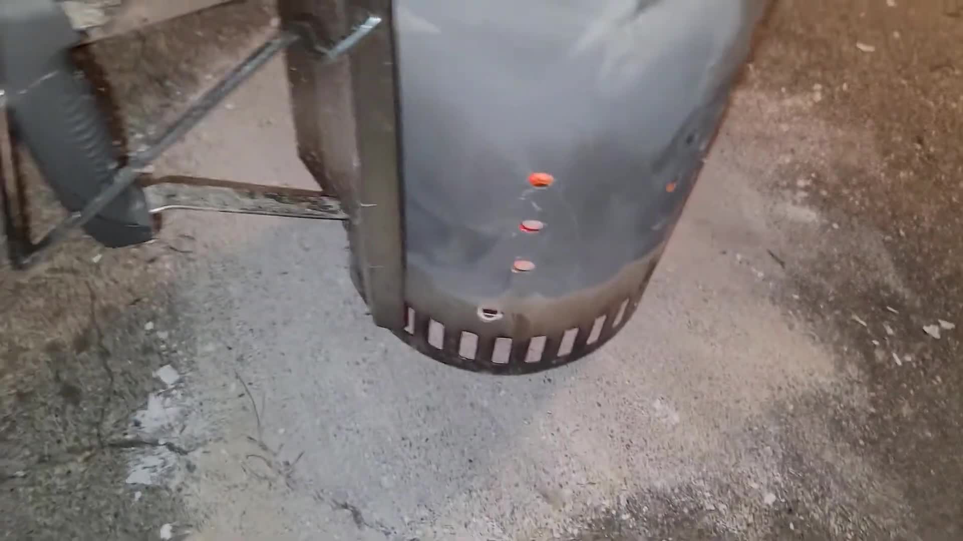 Close-up of scrap paper being used to light the charcoal chimney.