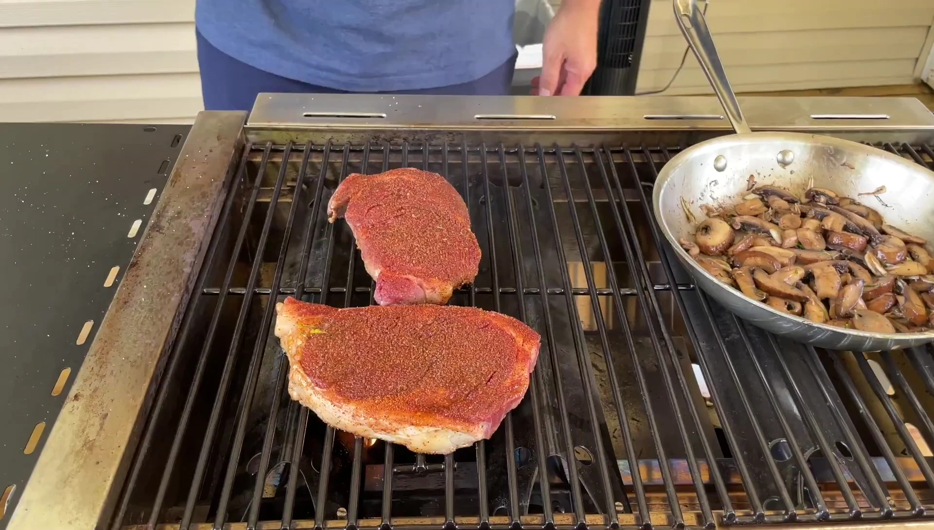 Steaks being flipped on the grill