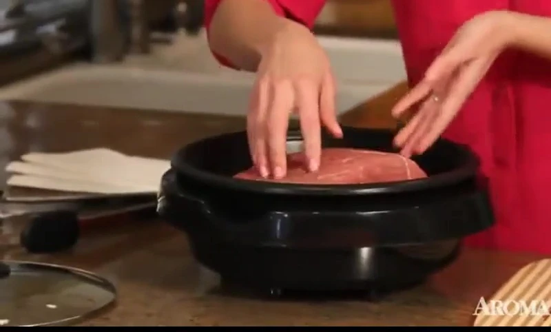 Preparing a slow-cooked beef pot roast in the Aroma Super Pot