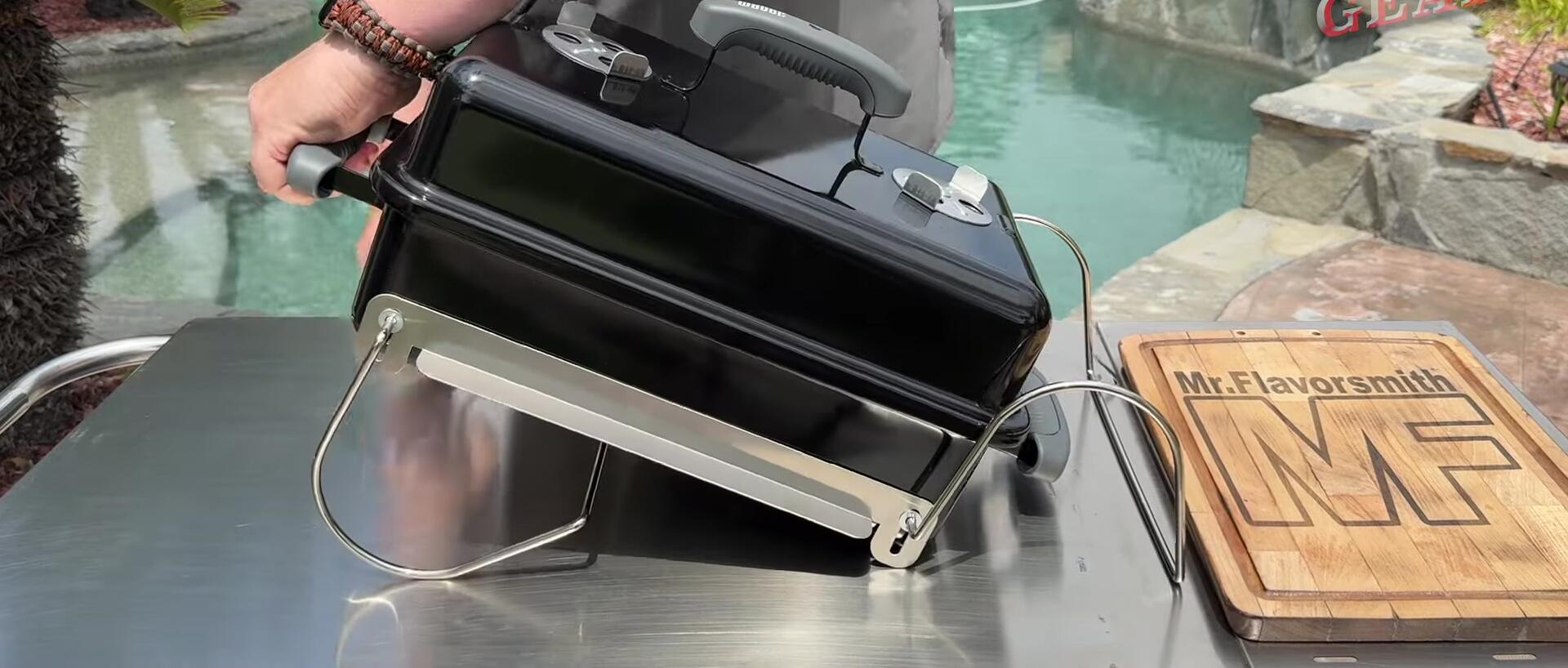 Demonstrating the folding and unfolding of the grill legs