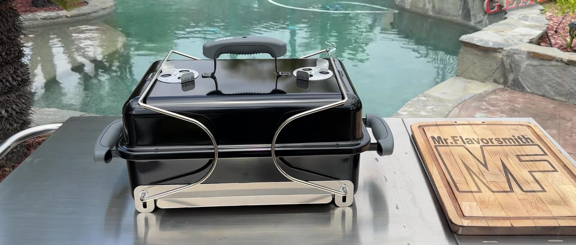 Opening the Weber Go-Anywhere grill to show its components