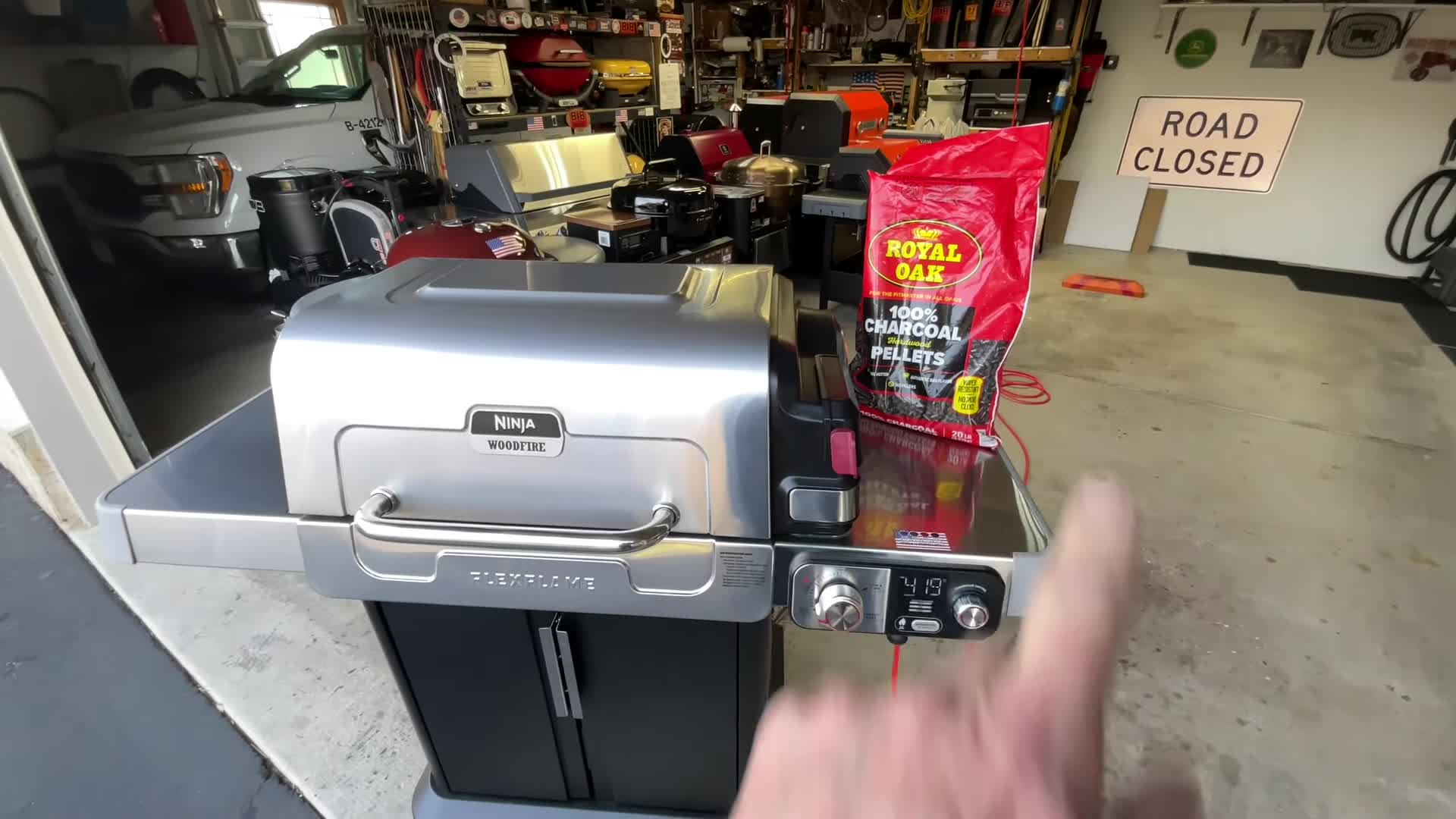Royal Oak charcoal pellets being added to the Ninja Woodfire Flex Flame grill.
