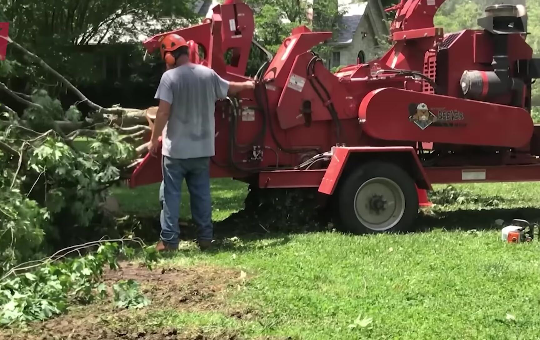 The chipper processing storm-damaged debris.