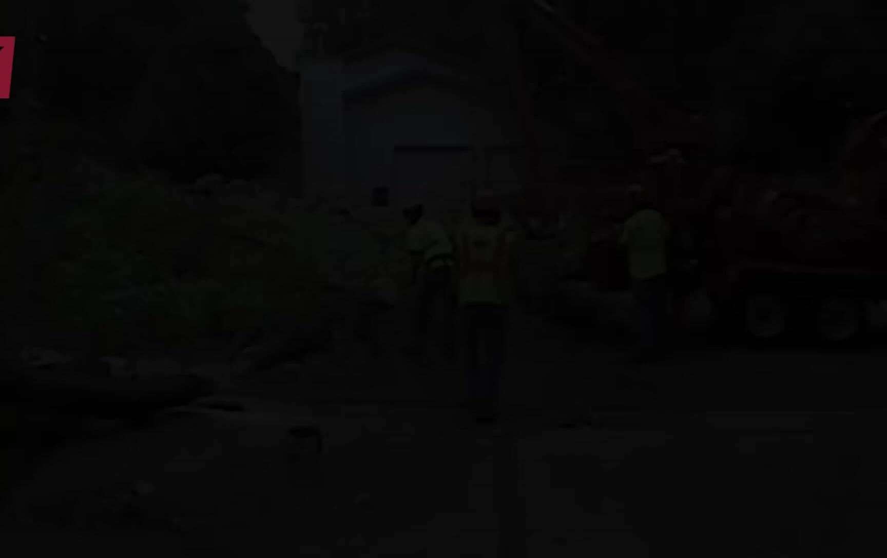 Tree removal crew working on a fallen tree blocking a road.