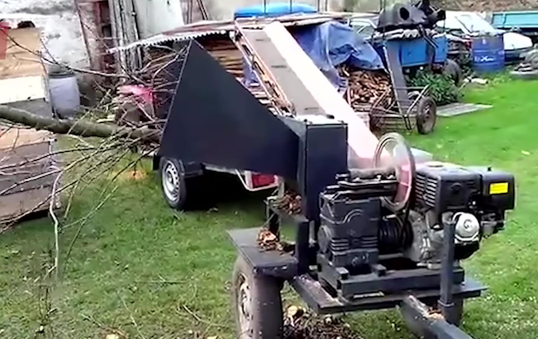 Branch shredder processing a pile of branches.