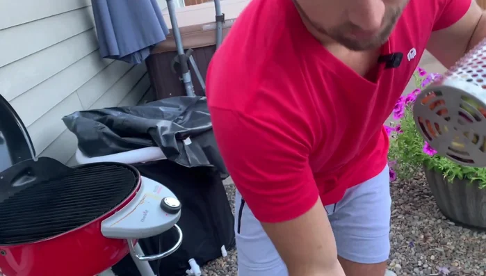 Place the grilling baskets on the grill using the built-in stands. Insert the basket handles into the grill grates' holes.