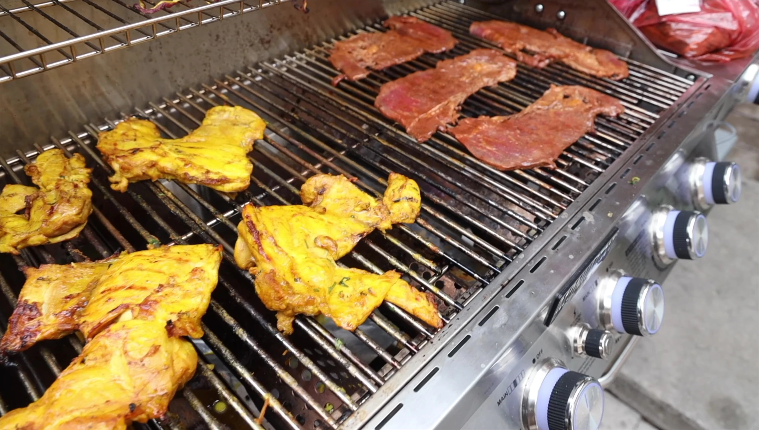 Wide shot showcasing the extensive cooking area of the six-burner grill.