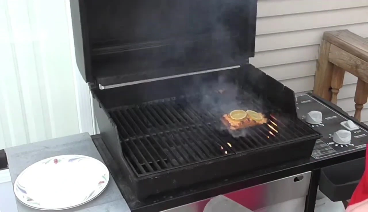 The spatula effortlessly removing the salmon from the grill.