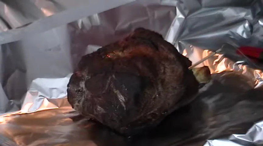 Applying BBQ sauce to the shoulder.