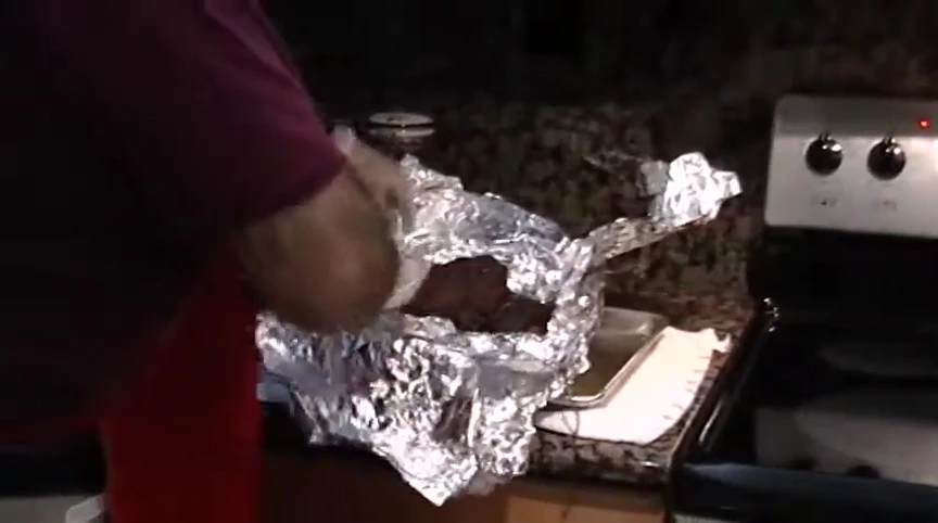 Unwrapping the finished picnic shoulder.