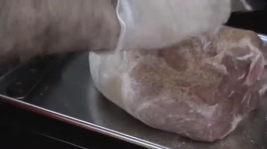 Seasoning the picnic shoulder.
