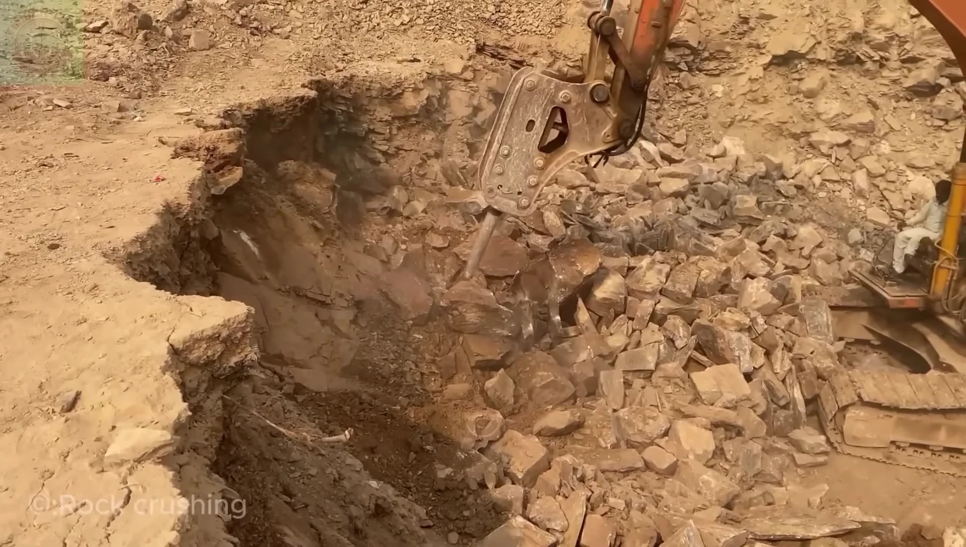 Dust cloud generated by the stone crushing operation.