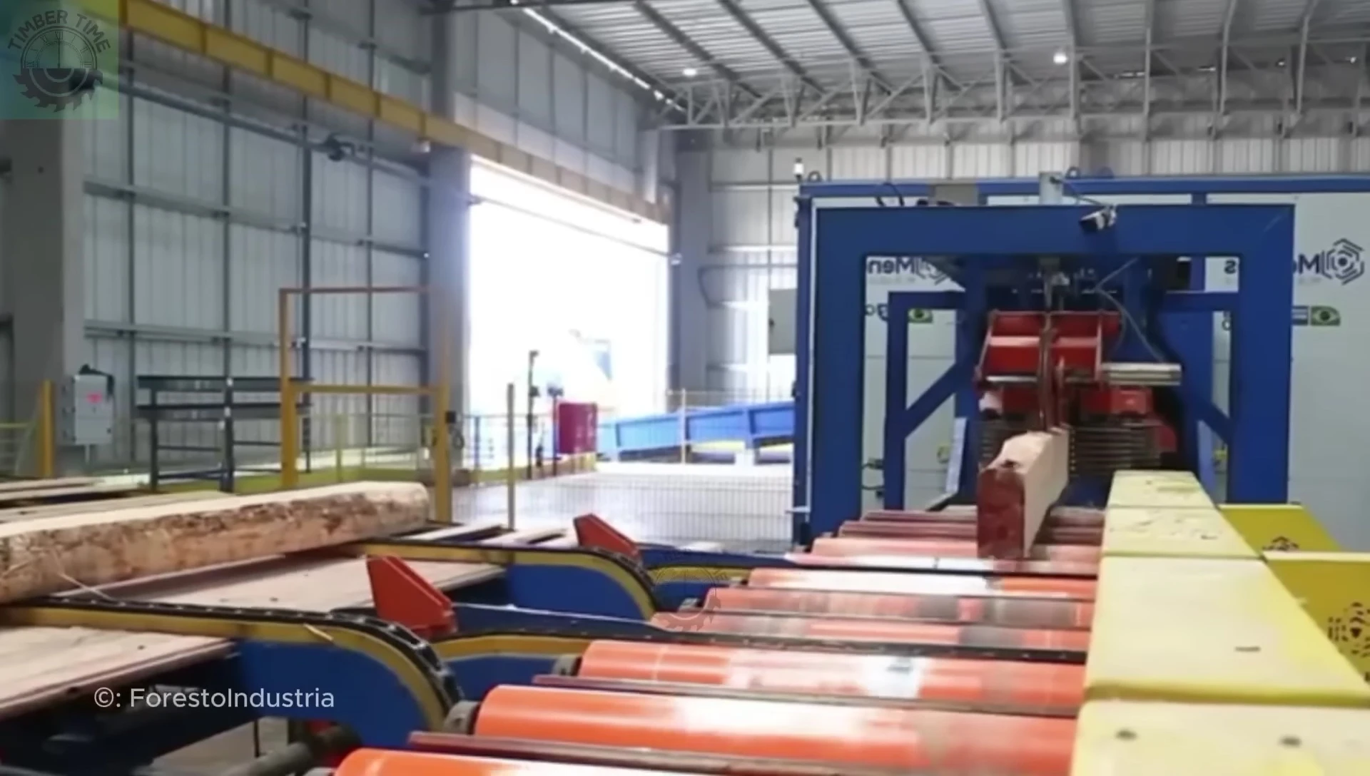 Close-up showing the automated log processing within the modern sawmill.