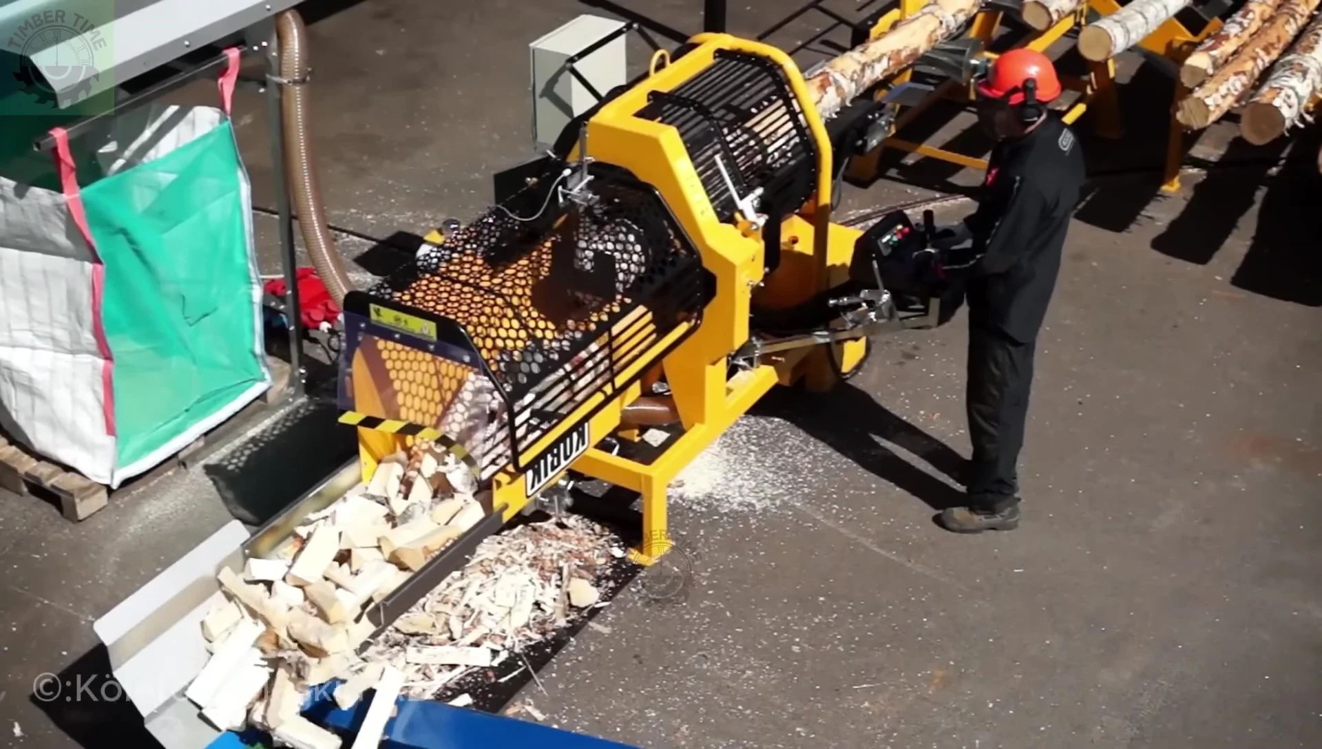 A person operating the Cubic 2013 Firewood Processor.