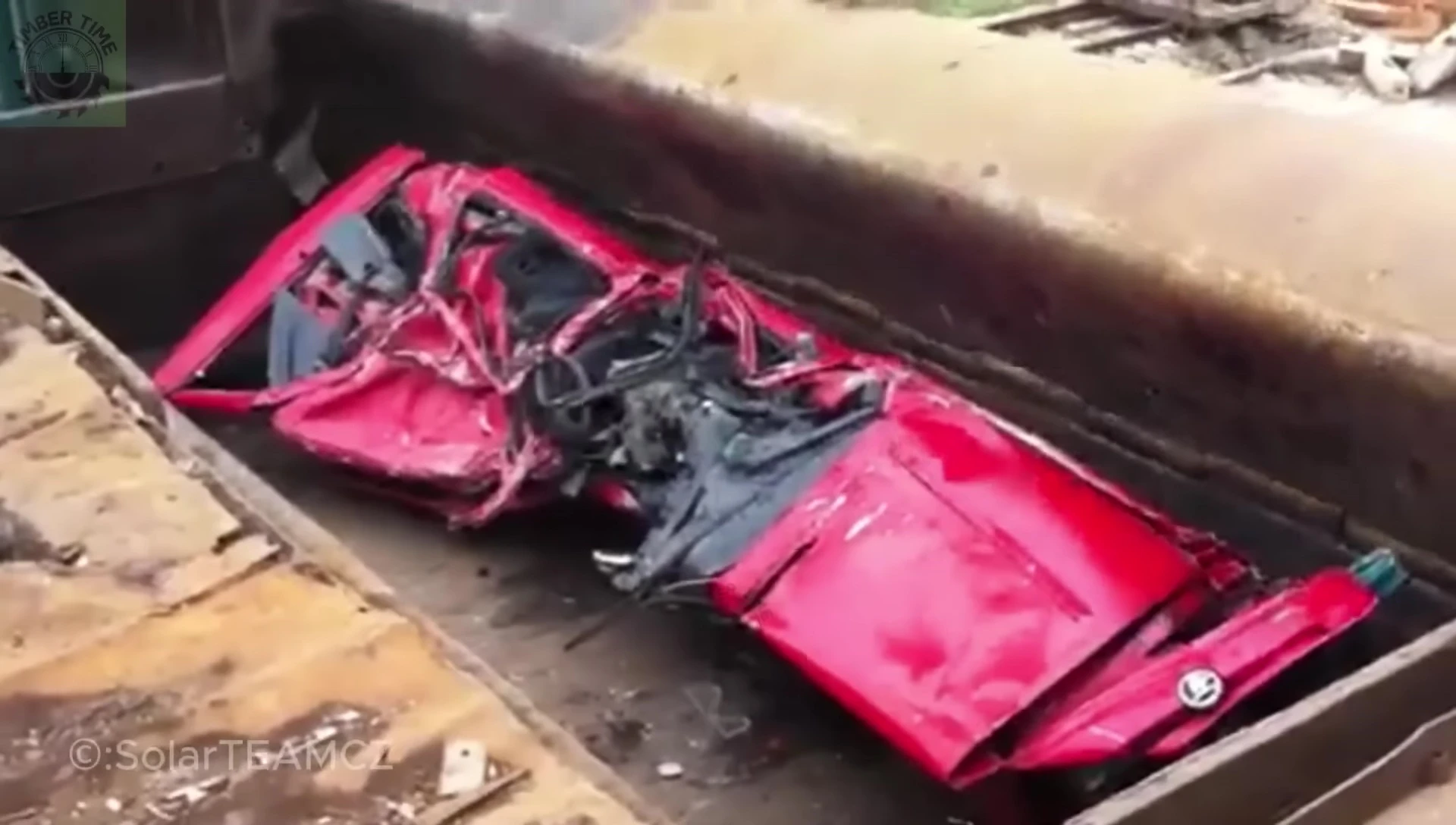 The hydraulic press crushing a car.
