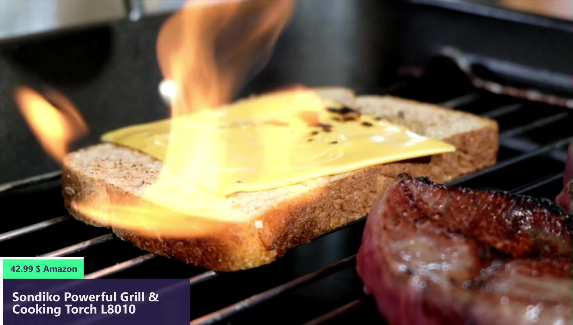 Close-up showing the long angled nozzle and finger guard of the culinary torch.