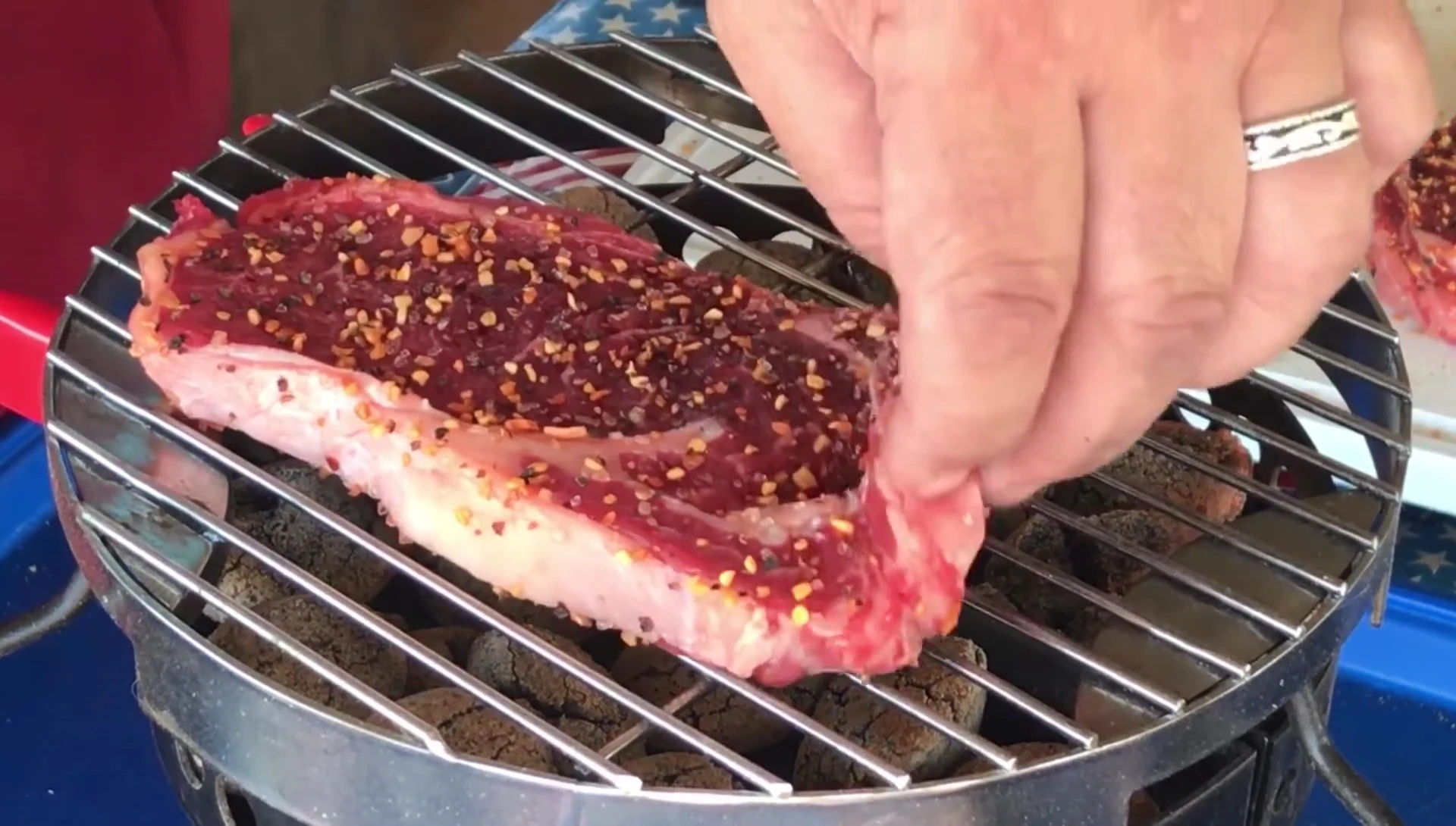Ribeye steaks sizzling on the grill.