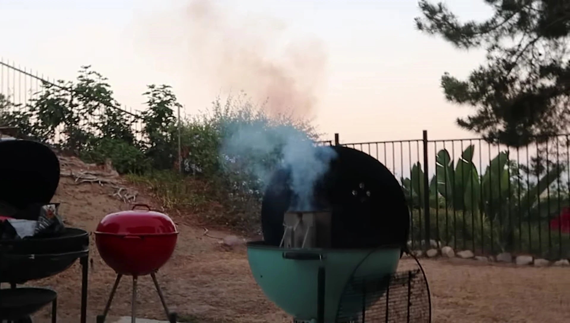 Smoke rising from the burning charcoal.