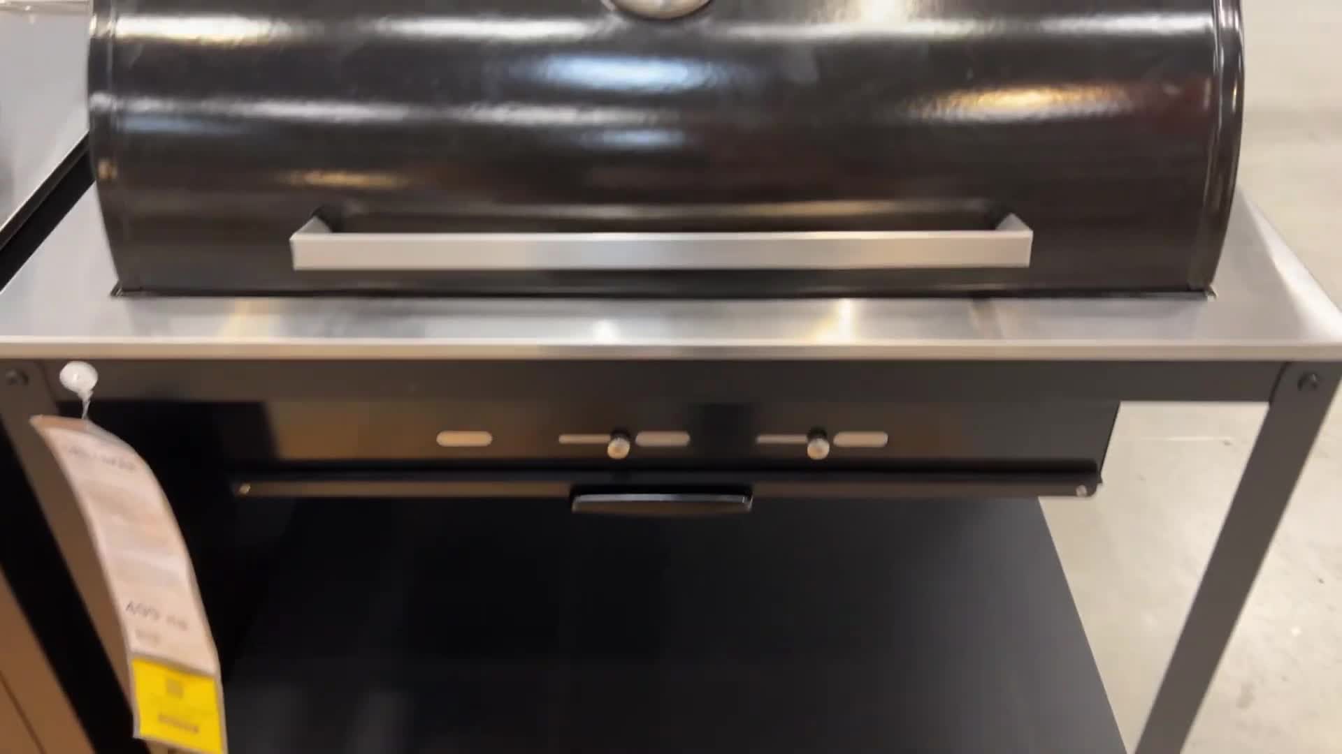A view of the grill's metallic lid and exhaust adjustment