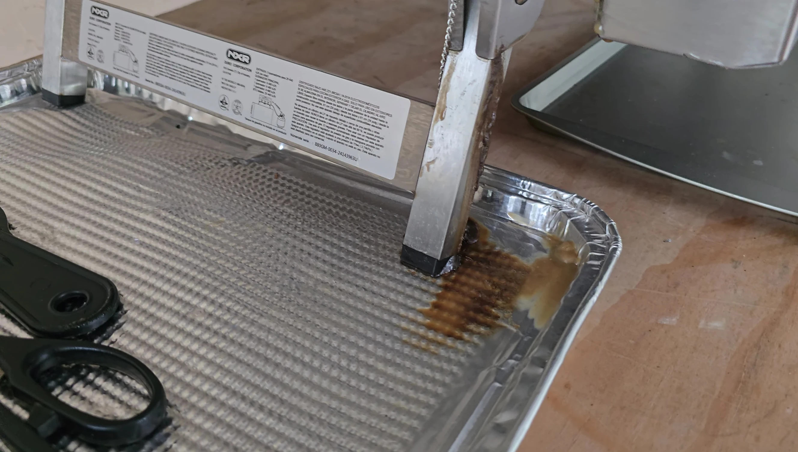 Grease dripping from the front leg of the grill.