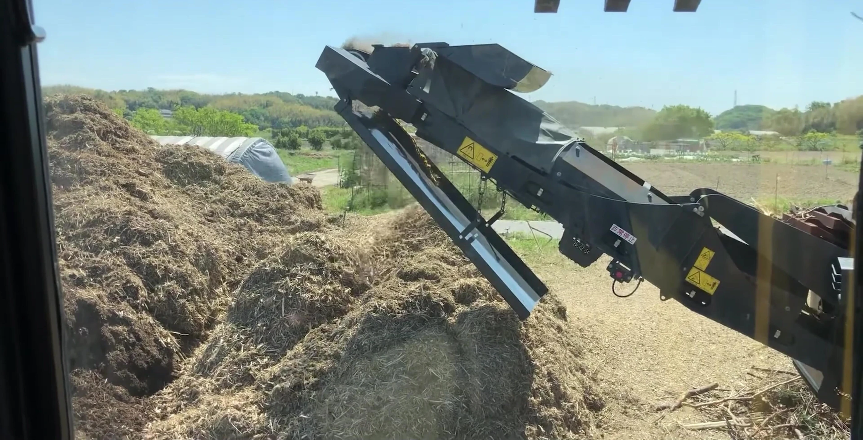 Kamatsu BR1 120T 1 wood chipper in operation, from the grapple operator's perspective