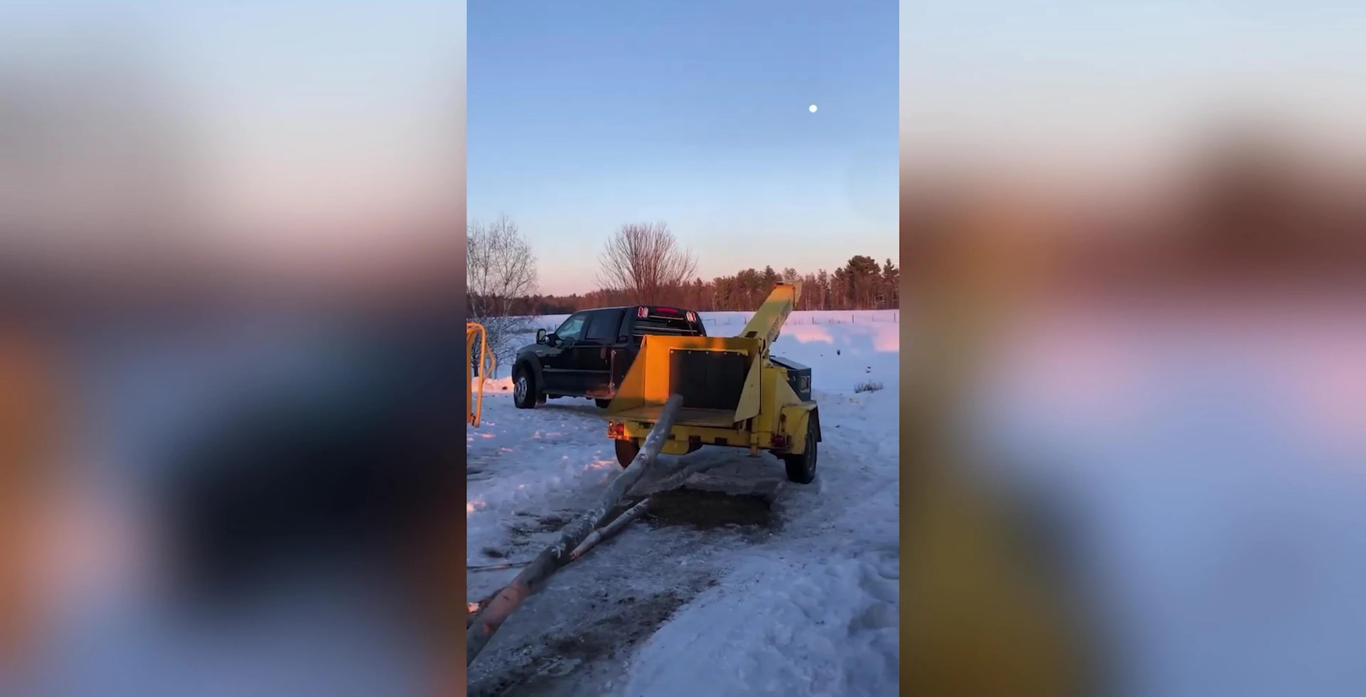 Wood chipper operating in a snowy landscape