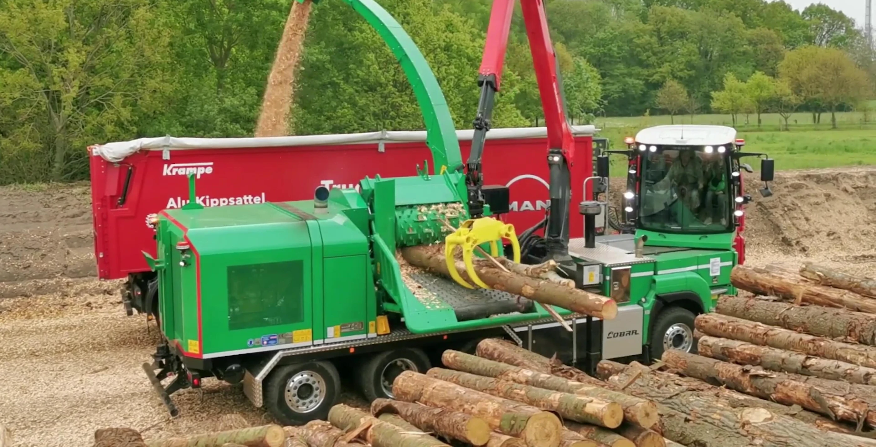 Stream of wood chips being ejected from the HM 821 Cobra Hybrid