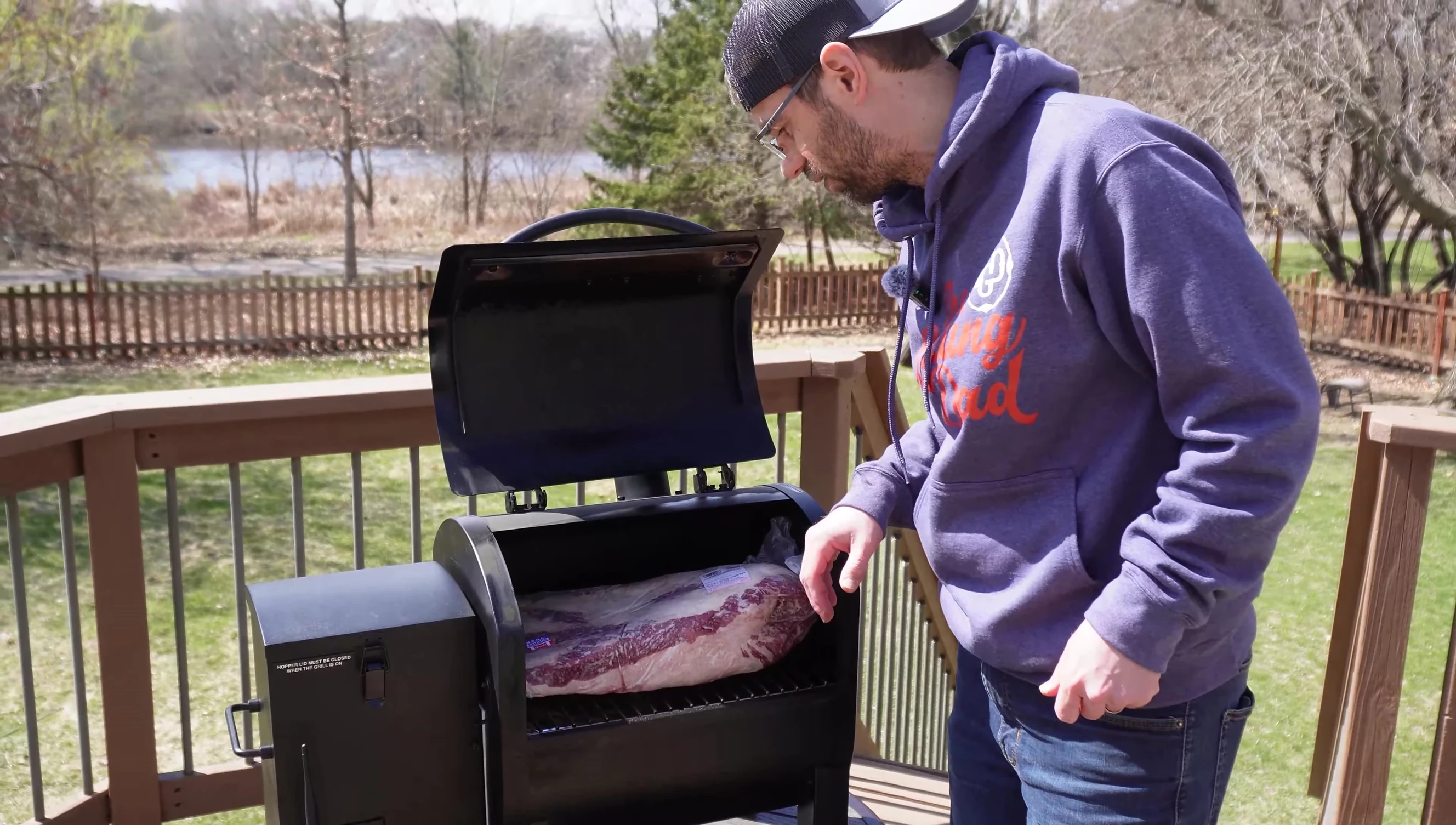 The brisket in the grill with the lid closed.