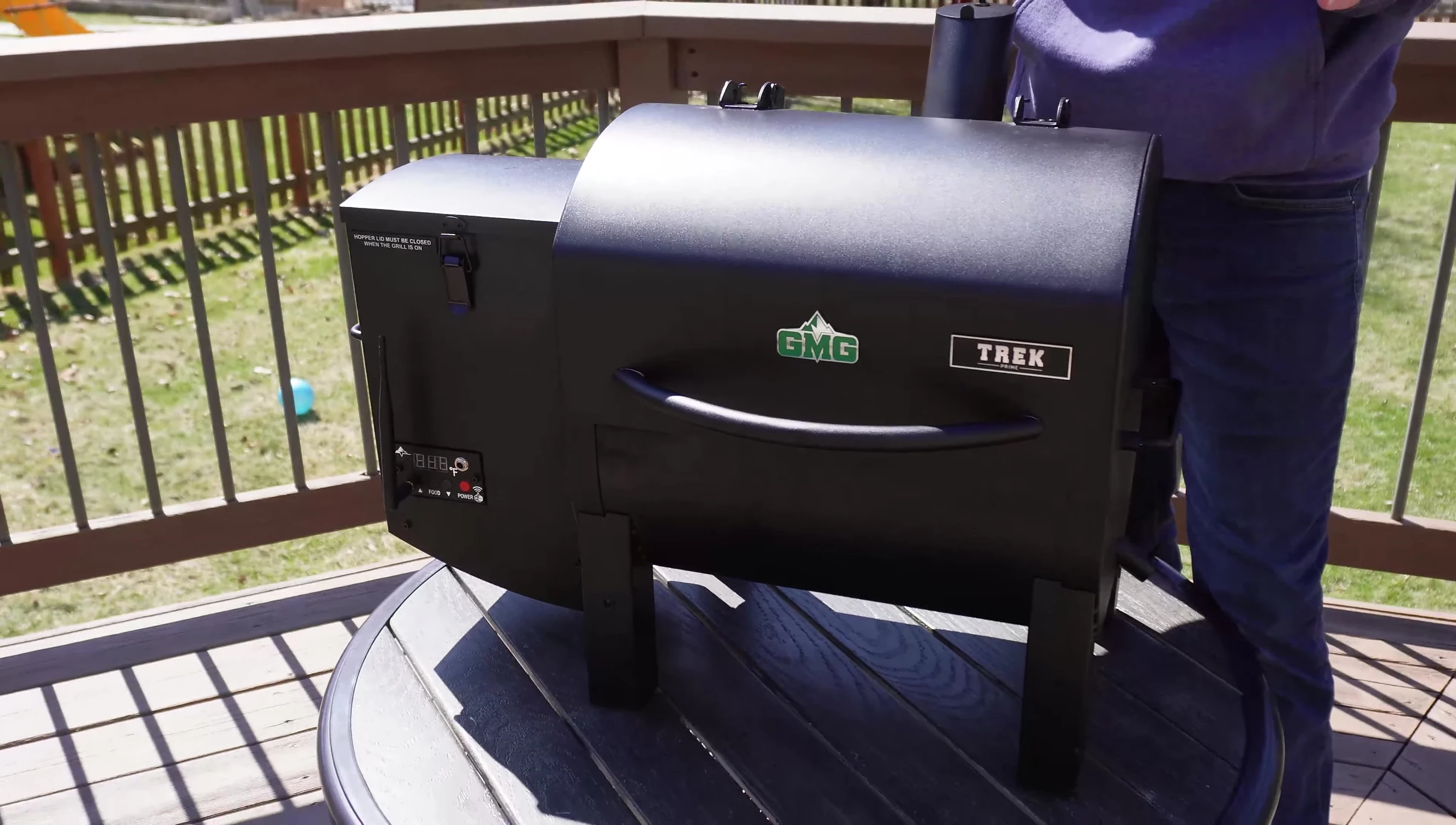 The grill being lifted to demonstrate its lightweight design.