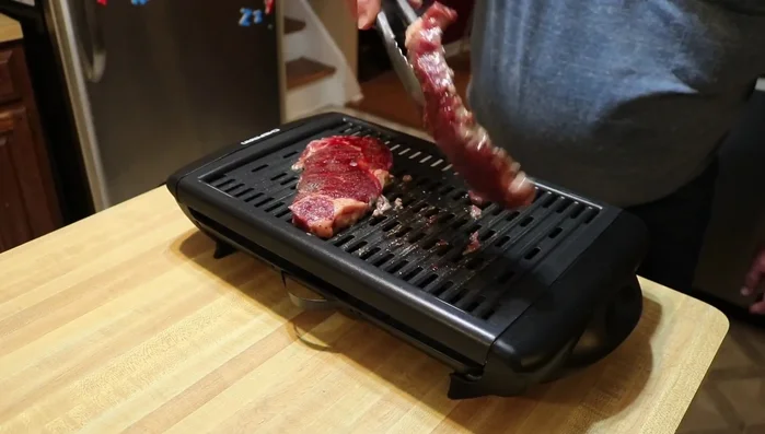 Adjust the steaks on the grill for even cooking if necessary.