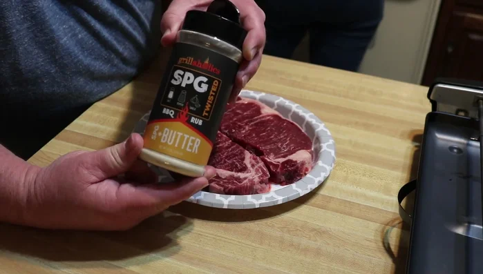 Prepare the steaks by applying Grillaholics SPG Plus butter.