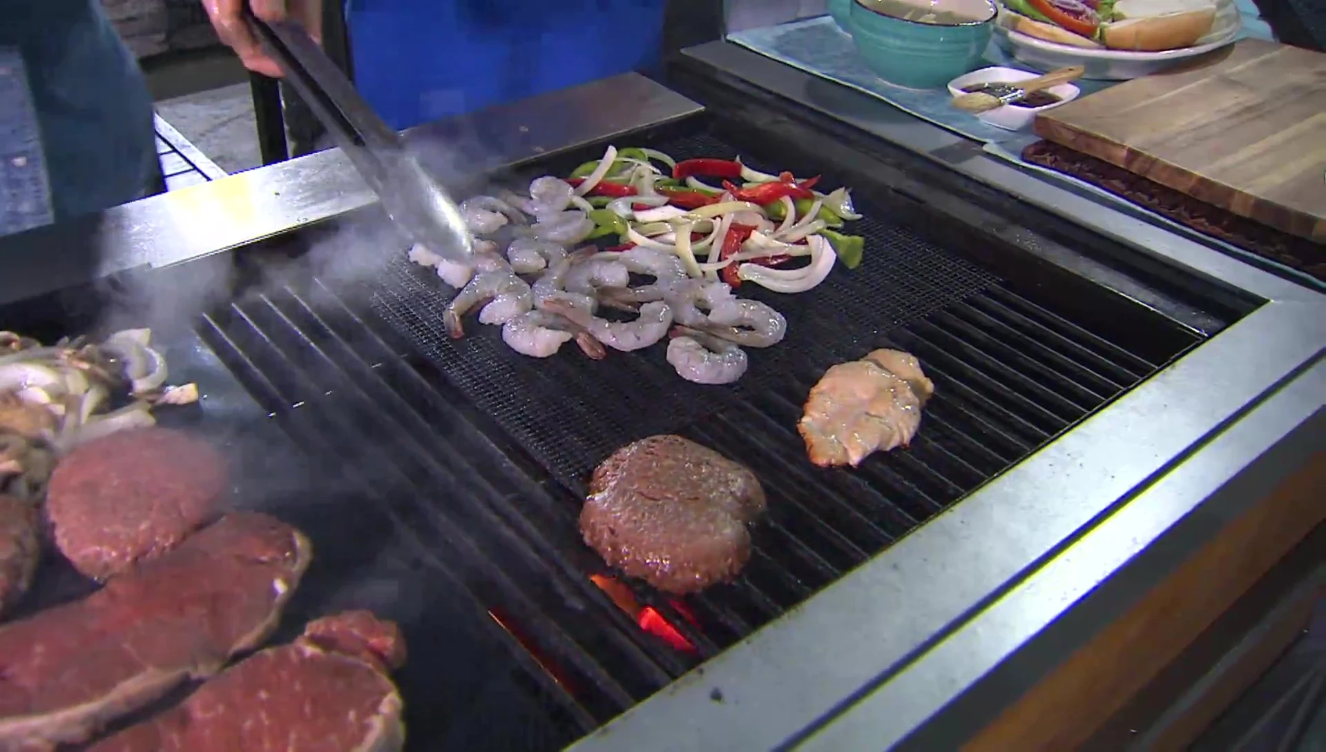 A burger cooking directly on the grill, showing significant flare-ups.