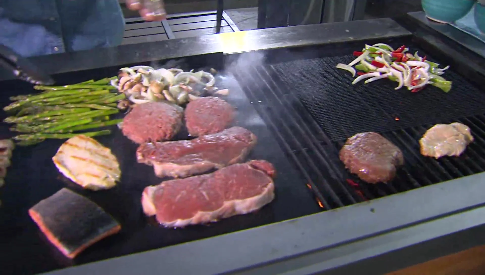 A wide shot showing the size comparison of the large grill mat.