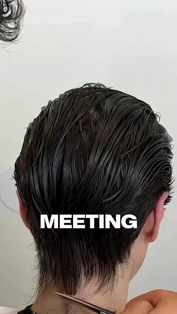 The barber cleaning up the client's neck and sideburns.