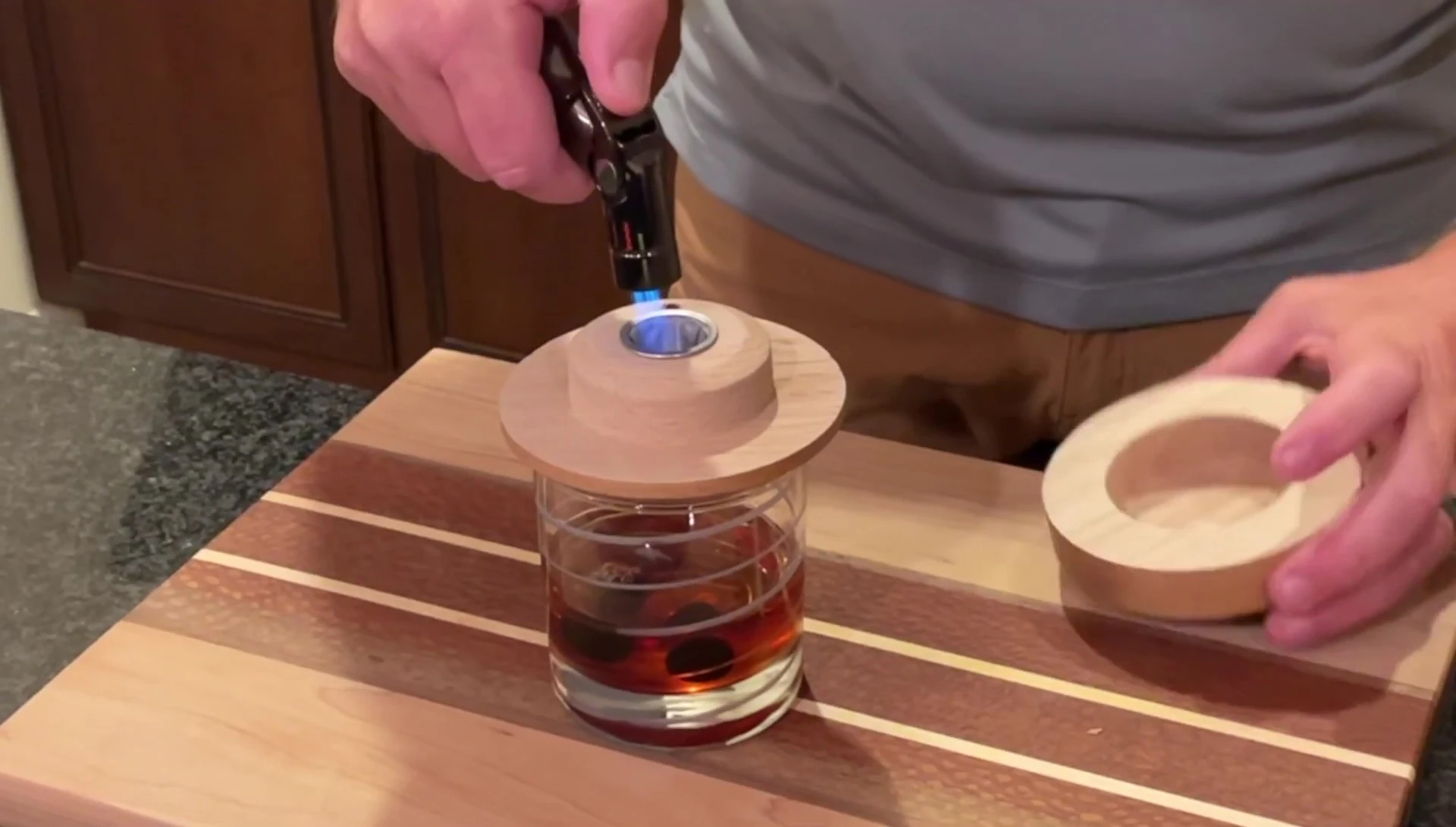 The process of smoking the Manhattan cocktail.