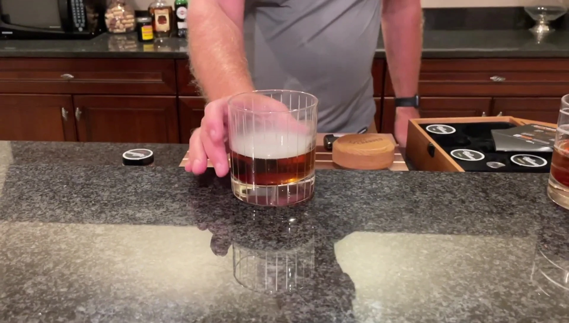 The reviewer enjoying the smoked Manhattan.