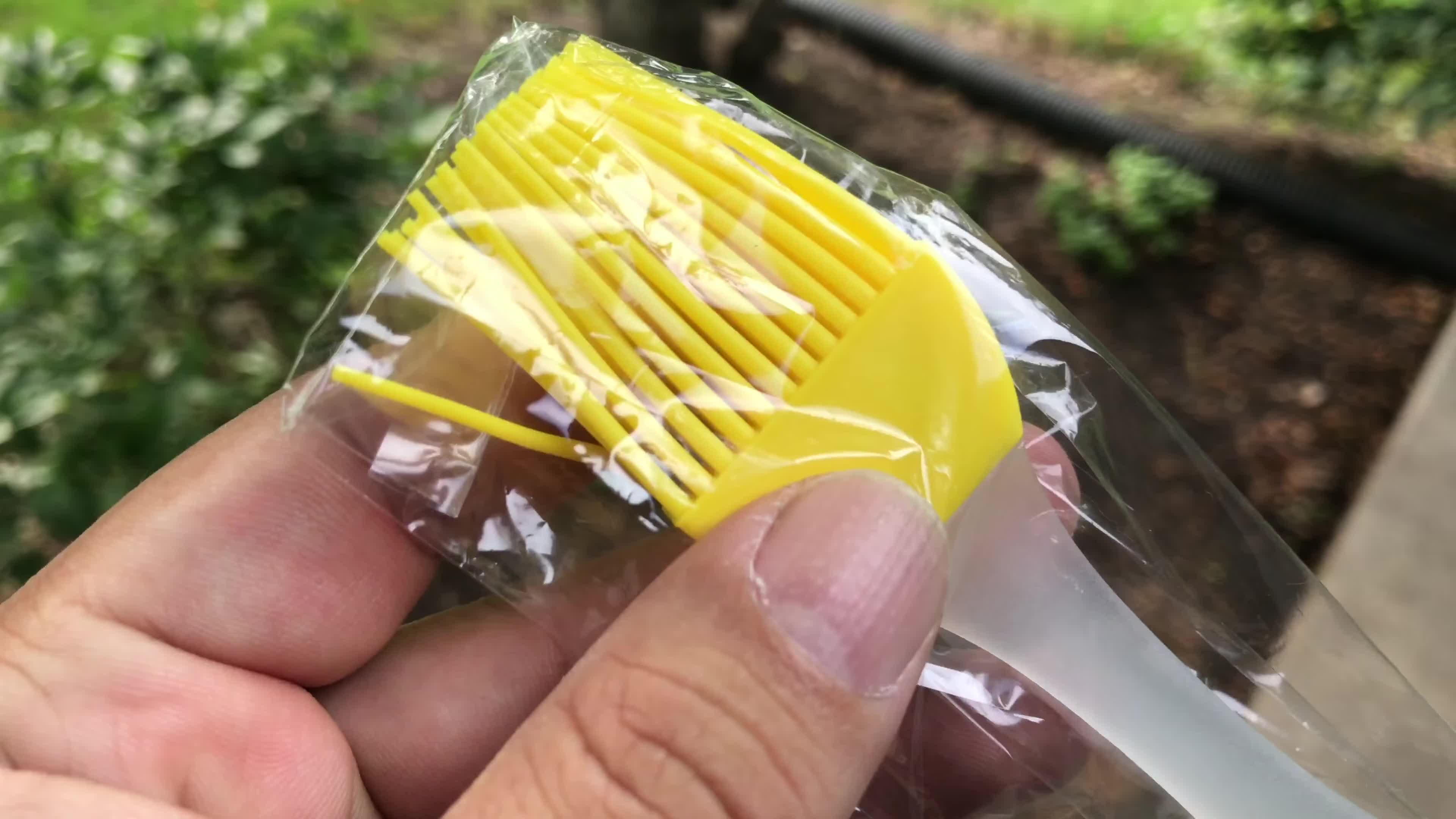 Close-up of the silicone basting brush included with the grill cleaner.