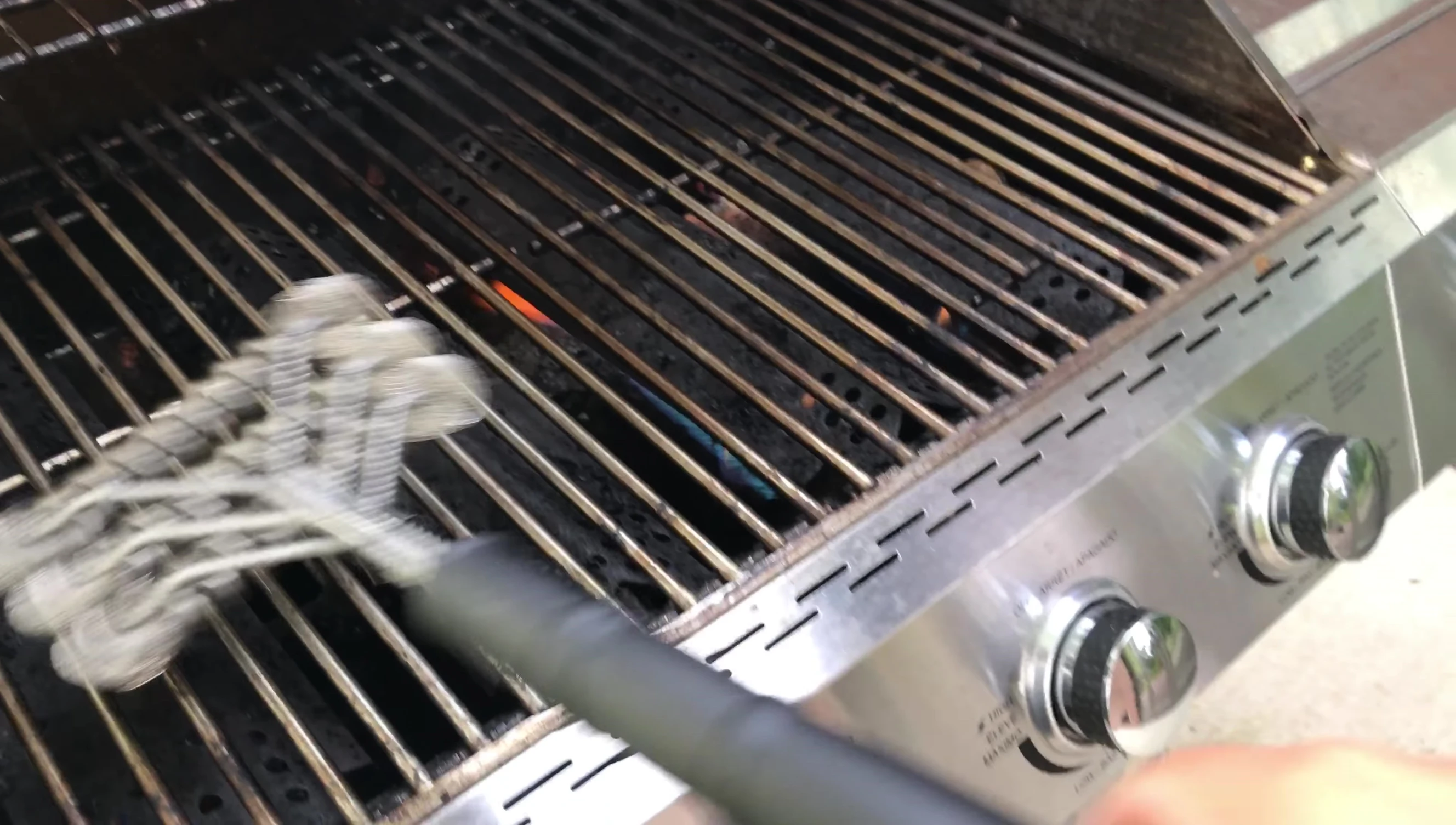 The brush in action on a hot grill.