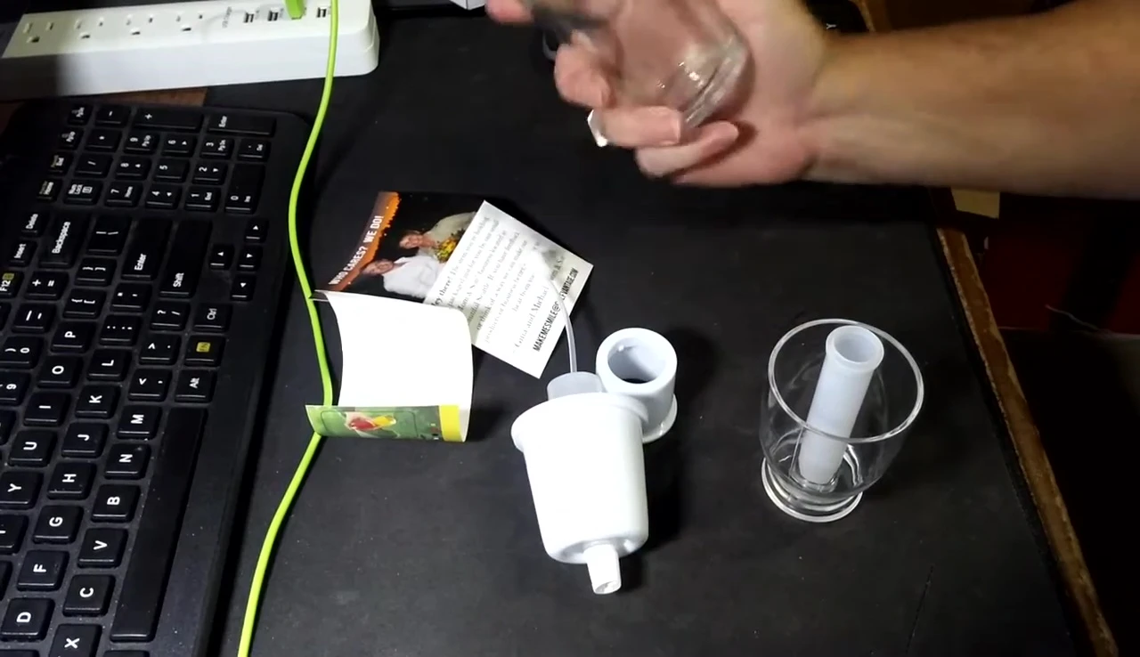 The presenter pouring oil into the sprayer.